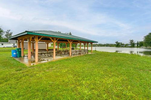 a pavilion with benches in a field next to a lake at Walk to Shay Lake Updated Home with Water View! in Silverwood