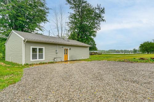 a small white house with a gravel driveway at Walk to Shay Lake Updated Home with Water View! in Silverwood