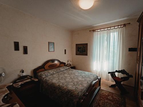 a bedroom with a bed and a window at Il Pellicano in Rovereto