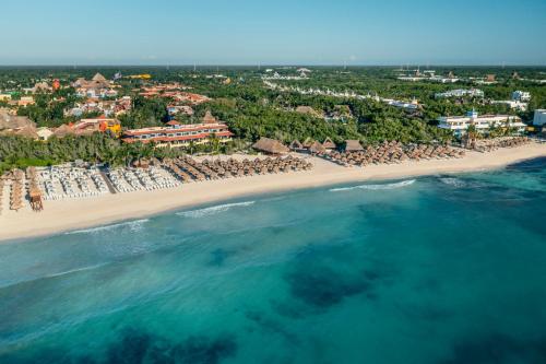 an aerial view of a beach with umbrellas and the ocean at Iberostar Waves Paraíso Beach - All Inclusive in Puerto Morelos