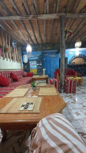 a large room with red chairs and a large wooden table at Azour House in Taghazout