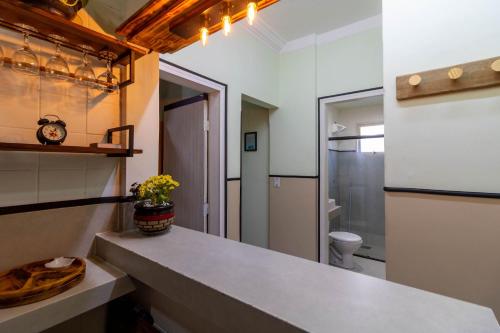 a kitchen with a counter and a toilet in a room at Ed. Residencial Negrão Lima | Goiânia in Goiânia