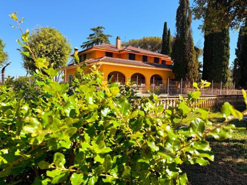 an orange house with trees in front of it at Villa Due Leoni - Casa Per Ferie in Rome