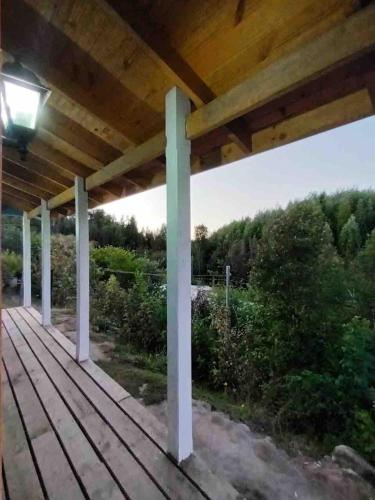 a wooden porch with a light on it at Blue Cabin - La Herradura 