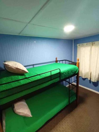 a bedroom with two bunk beds in a room at Blue Cabin - La Herradura 
