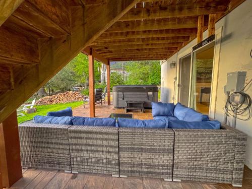 a large couch in a living room with a grill at Lakefront A-frame Hot Tub, Dock, Kayaks, Games in Lake Ariel