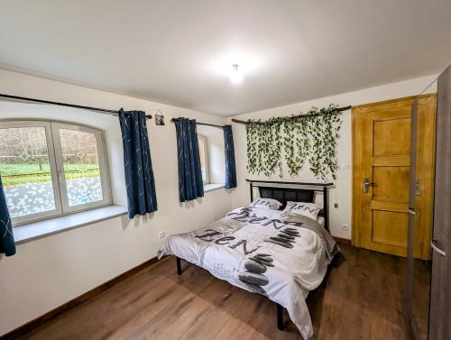 a bedroom with a bed and a window at Domaine du KleinHammer in Windstein