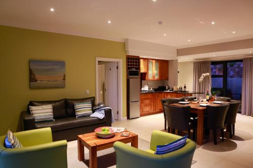 a living room with a couch and a table at Brenton Haven Beachfront Resort in Knysna