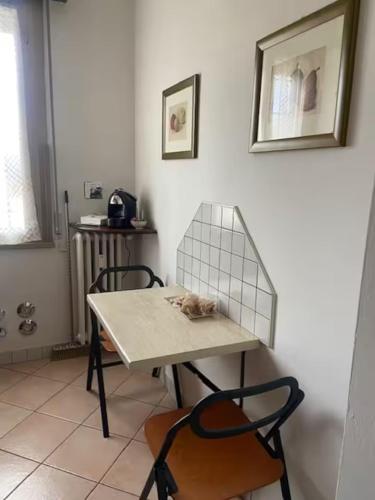 a table and two chairs in a room at Ca Nora in Sasso Marconi