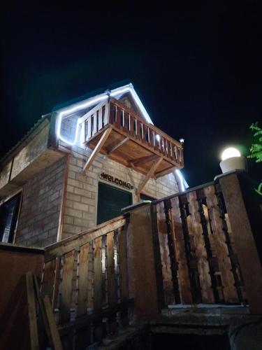 a building with a deck on top of it at Сказочный Дилижан in Dilijan