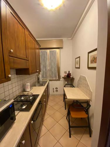 a kitchen with a stove and a table in it at Ca Nora in Sasso Marconi