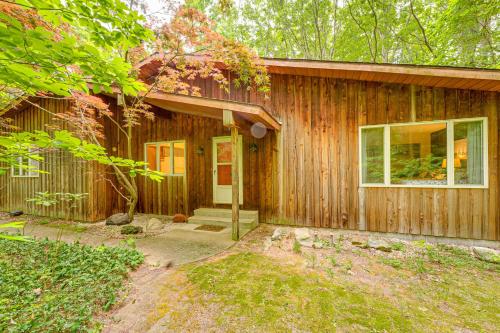 a wooden house with a door and a window at Less Than 1 Mi to Lake Michigan Peaceful Cabin with Yard! in Whitehall