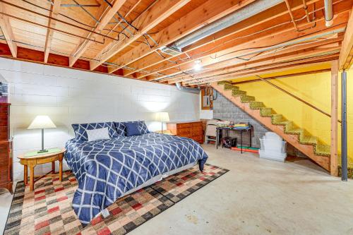 a bedroom with a bed and a staircase at Less Than 1 Mi to Lake Michigan Peaceful Cabin with Yard! in Whitehall