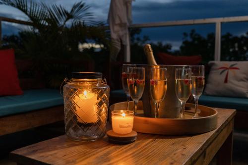 a table with wine glasses and a candle on it at Tiny Village Cartagena Boutique Resort in Tierra Bomba
