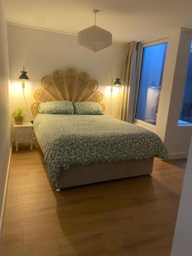 a bedroom with a bed and a window at Mumbles holiday home in The Mumbles