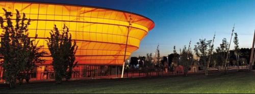 a large building with a yellow and orange roof at Maison privative SPA Jacuzzi Sauna Salle de jeux in Weitbruch