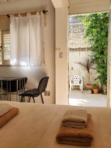 Un dormitorio con una cama con dos toallas encima. en Casa de Invitados 2, en Pergamino