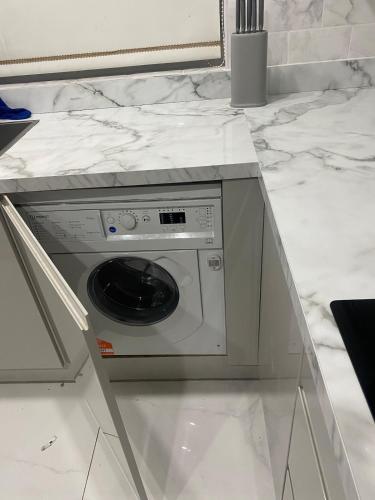 a washing machine in a counter in a kitchen at Twinhorse in Prescot