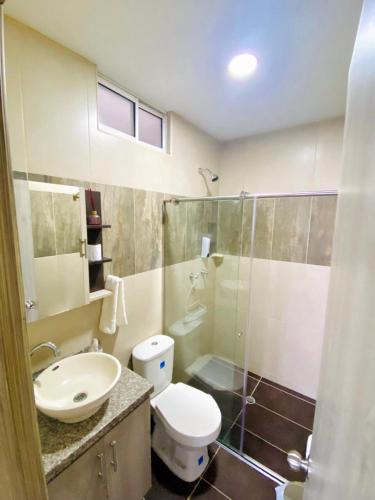 a bathroom with a toilet and a sink and a shower at Santa Isabel Centro 302 in Santa Rosa de Cabal