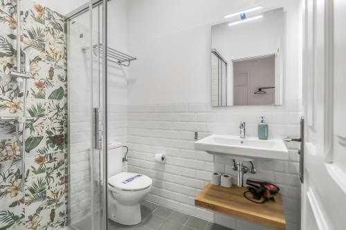 a bathroom with a sink and a toilet at City Garden Suites Nadami 1935 in Las Palmas de Gran Canaria