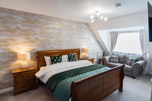 a bedroom with a bed and a couch and a chair at Dublin Premier Homestay in Ráth Cúil