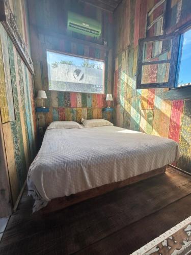 a bedroom with a bed in a room with a window at La mar in La Pedrera