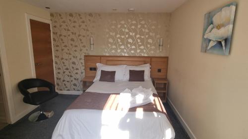 Ένα ή περισσότερα κρεβάτια σε δωμάτιο στο Granada Apartments Queens Mansions