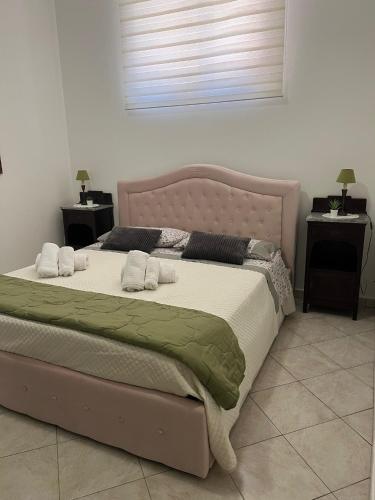 a bedroom with a large bed with two night stands at Casa Vacanze - VIOLA HOUSE by La Casa di Viola - Marsala in Marsala