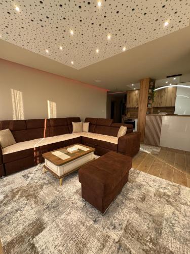 a living room with a couch and a coffee table at Crown Apartmani Vlašić in Vlasic