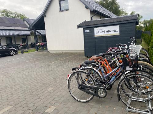 a group of bikes parked in a parking lot at Domki Błażejewo in Łukęcin