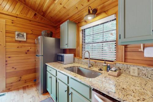 a kitchen with a sink and a refrigerator at Happy Top Hideaway in Bryson City