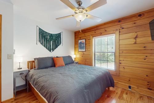 a bedroom with a bed and a ceiling fan at Happy Top Hideaway in Bryson City
