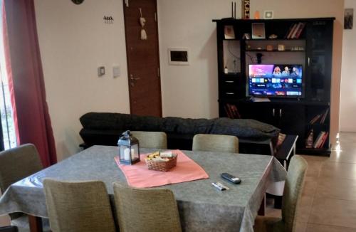 a living room with a table and a couch at Funes Inn in Funes
