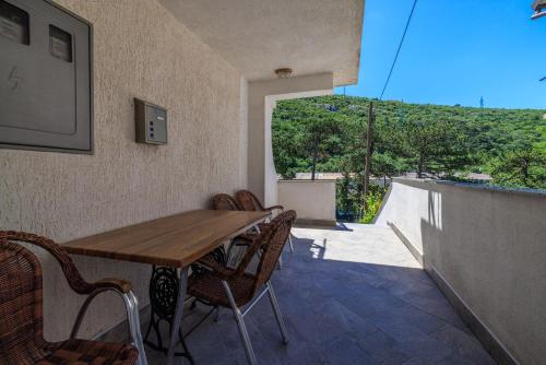 Un comedor con mesa y sillas de madera. en Apartment Dijana, en Senj