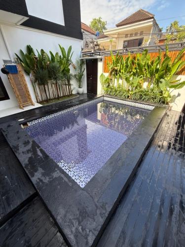 a swimming pool in the middle of a house at The Aura Inn in Kerobokan