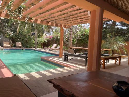 a swimming pool with a pergola and a table at Casa mia in Saly Portudal