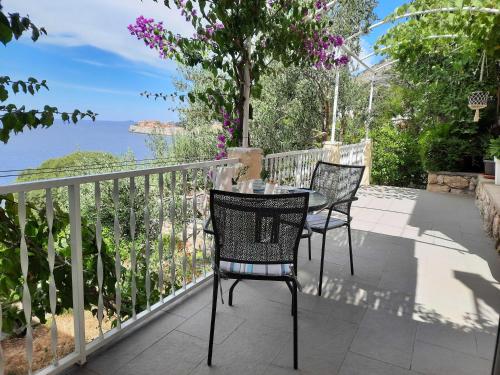 two chairs and a table on a balcony at Apartments Kirigin in Dubrovnik