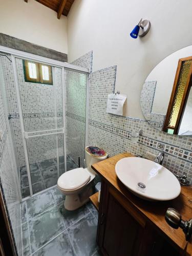 a bathroom with a shower and a toilet and a sink at Magical farmhouse near Arví Park in Mazo