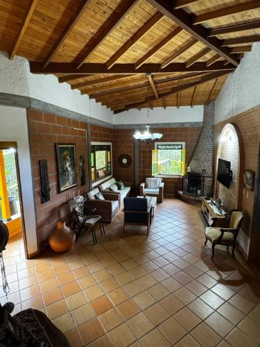 a living room with couches and chairs and a fireplace at Magical farmhouse near Arví Park in Mazo