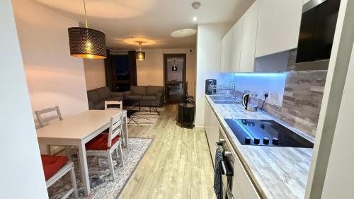 a kitchen with a sink and a table in a room at Luxury Stay ,London ,Wembley Stadium BOOk now in London