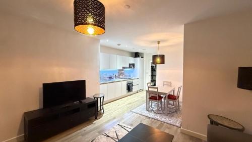 a living room with a television and a dining room at Luxury Stay ,London UK,Wembley Stadium BOOk now in London