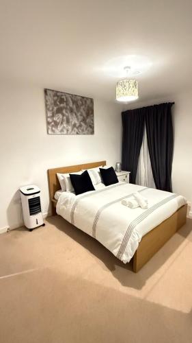 a bedroom with a large bed and a window at Luxury 2Bed 2 bath with free Parking NEAR WEMBLEY STADIUM Book Now in London