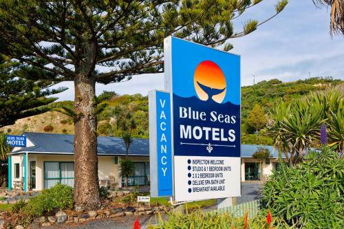 a blue seas motel sign in front of a house at Blue Seas Motel in Kaikoura