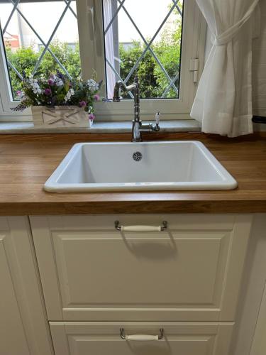 a white sink in a kitchen with a window at Charming Beachfront Retreat in Riposto