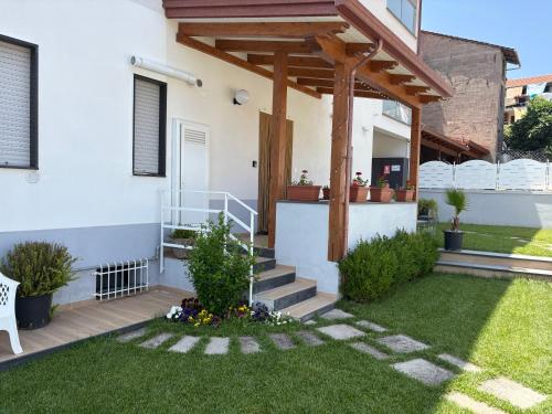 a house with a wooden pergola in a yard at Agerola Dreams in Agerola