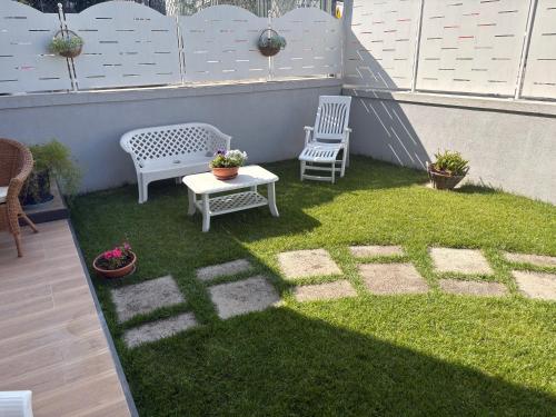 a small yard with two chairs and a table on a patio at Agerola Dreams in Agerola