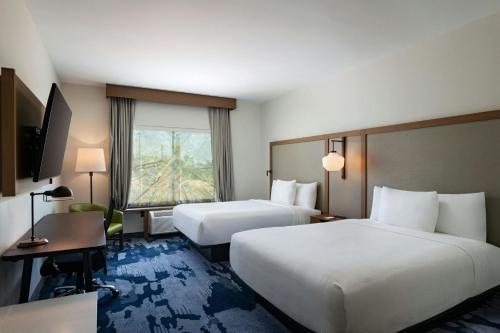 a hotel room with two beds and a window at Fairfield Inn & Suites by Marriott Harlingen in Harlingen