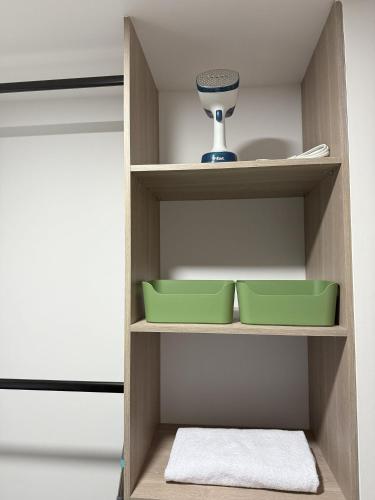 a cupboard with two bowls and a vase on it at BIT by Simple stay in Medellín