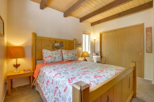 a bedroom with a large bed with a wooden headboard at Lake Arrowhead Family Home with Game Room in Lake Arrowhead