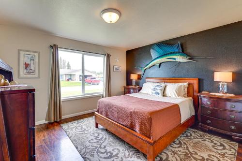 a bedroom with a bed with a fish on the wall at Soldotna Home with Yard, Walk to Kenai River! in Soldotna